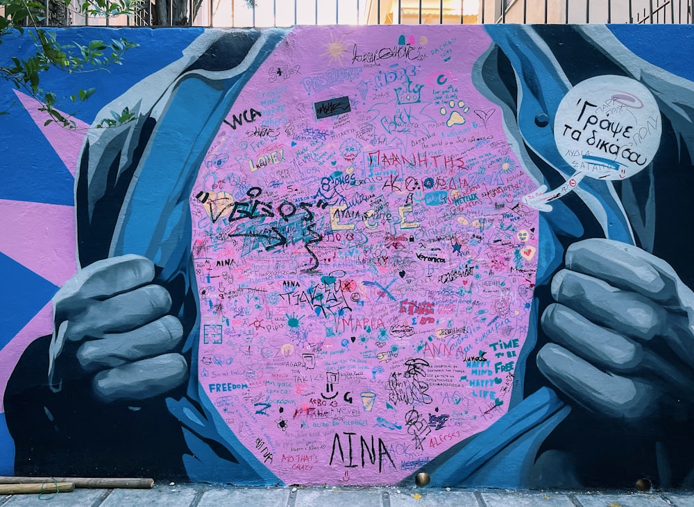 a mural of a man's torso covered in graffiti