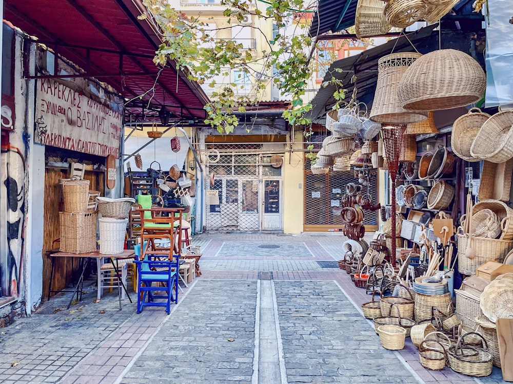 a narrow street lined with lots of baskets