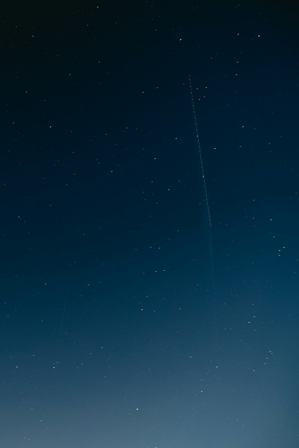 an airplane is flying in the sky at night