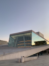 a large building with a glass front and stairs leading up to it