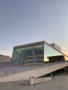a large building with a glass front and stairs leading up to it