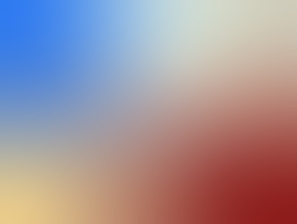 a blurry image of a red, yellow, and blue background