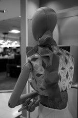 Photo of a stylish blouse displayed on a mannequin in a bright studio
