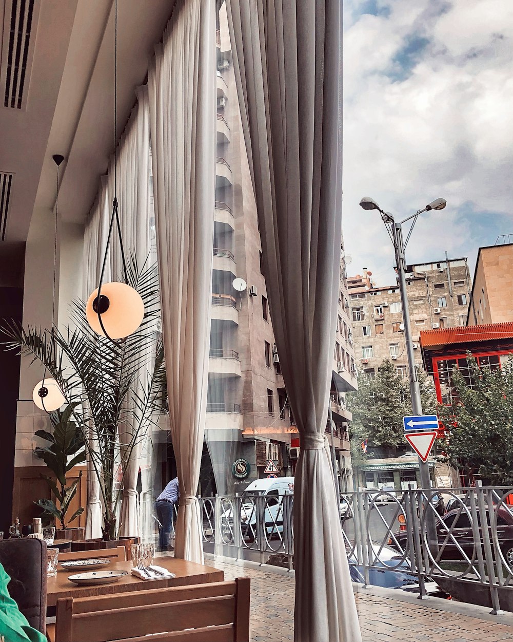 a view of a street from a restaurant window