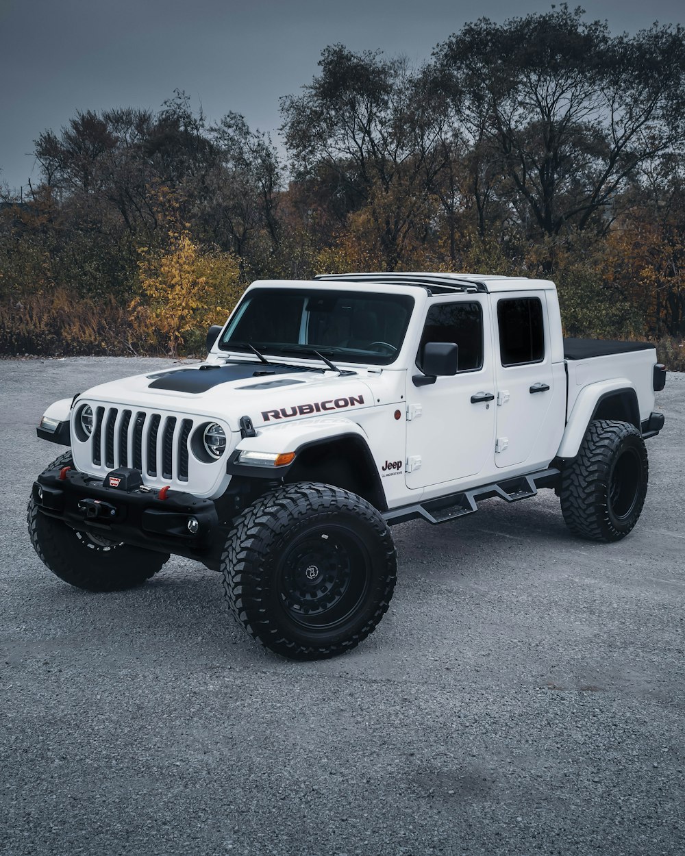 a white jeep parked in a parking lot