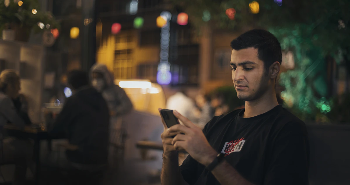 Man smiling at a flirty text on his phone