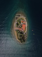 an aerial view of a small island in the middle of the ocean