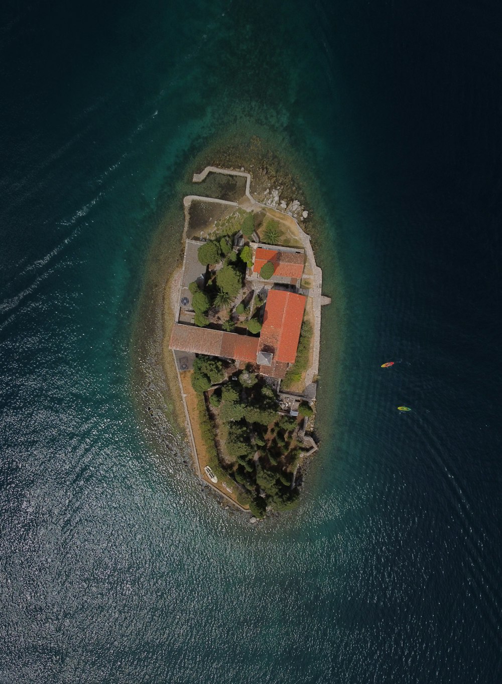 an aerial view of a small island in the middle of the ocean