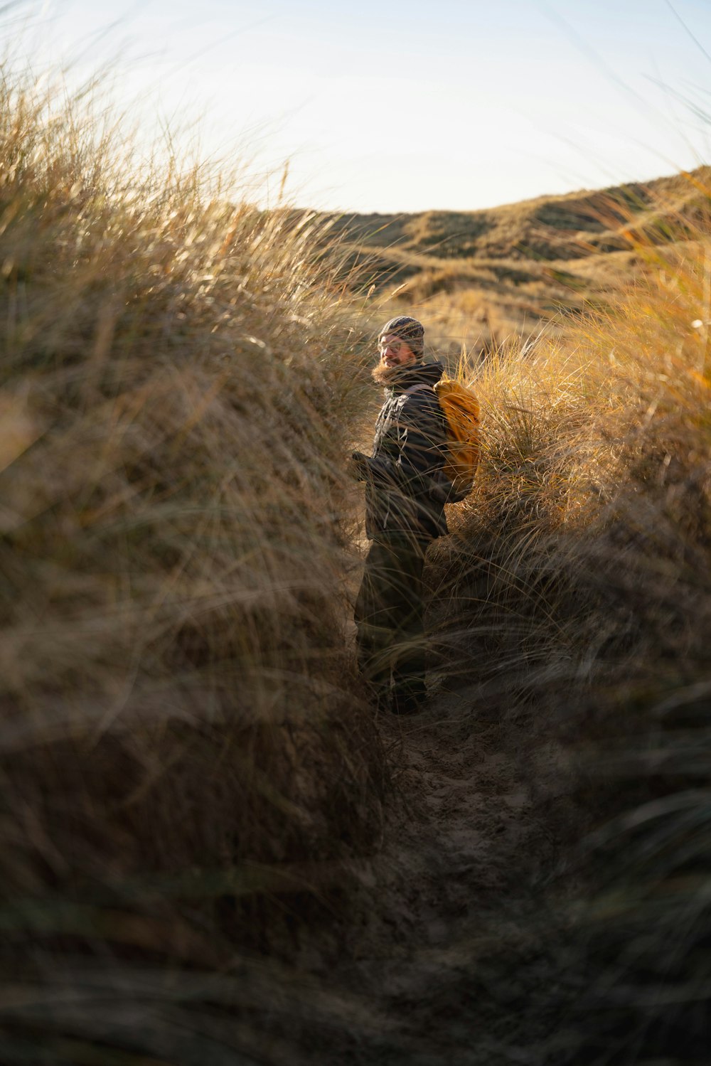 a man standing in a field of tall grass