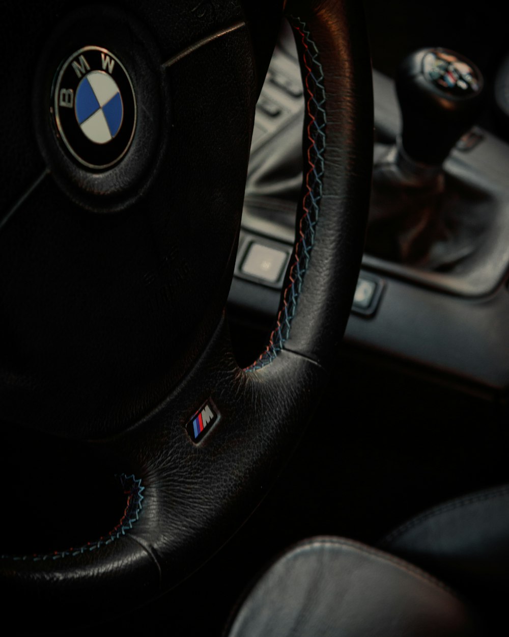the steering wheel of a car with a bmw emblem on it