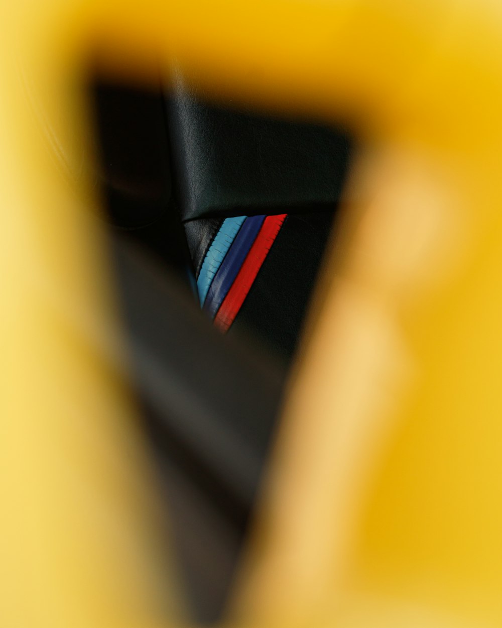 a close up of a colorful tie on a yellow chair