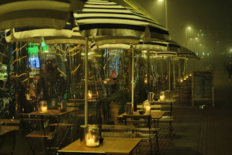 A Parisian café table set at night, with soft candlelight and velvet textures.