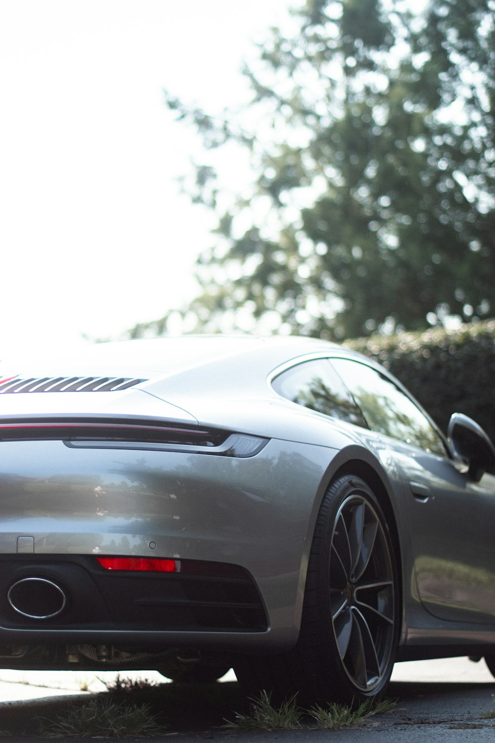 a silver sports car parked on the side of the road