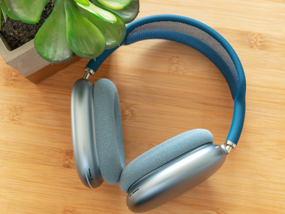 a pair of headphones sitting on top of a wooden table