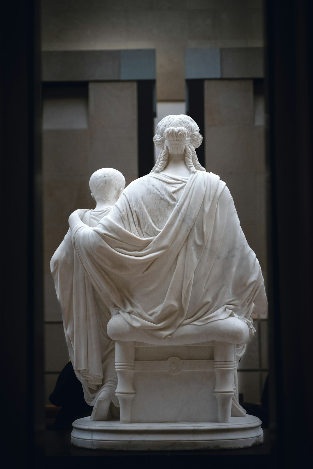 a statue of a woman sitting on a bench