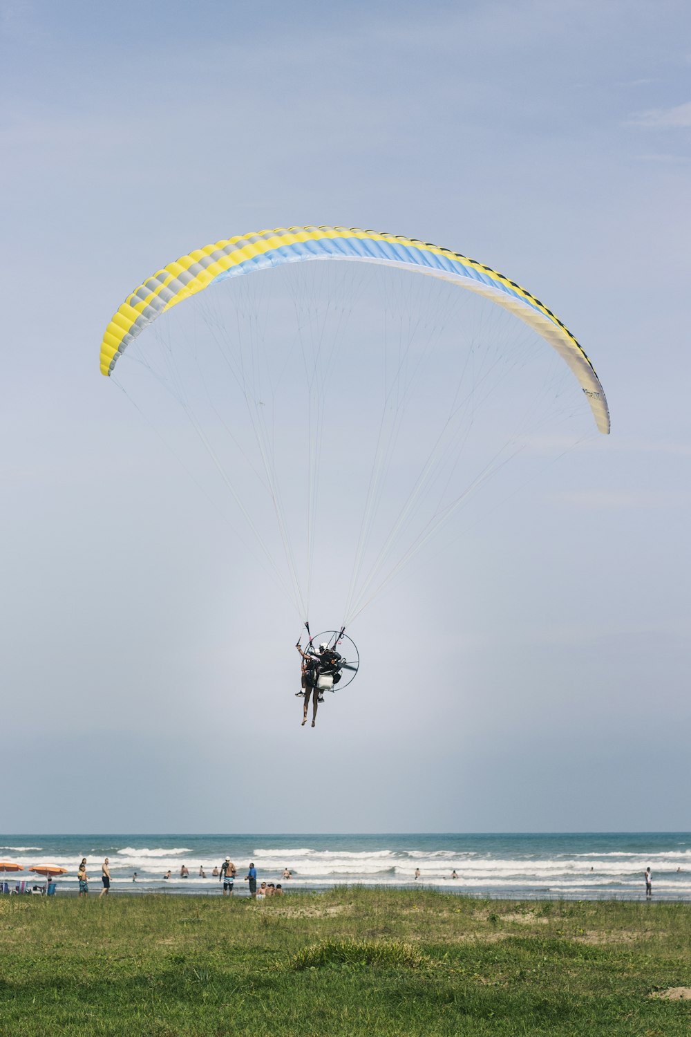 a parasailer in the air over a beach