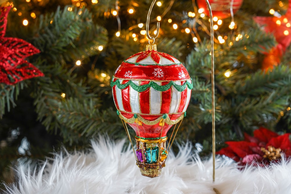 a hot air balloon ornament hanging from a christmas tree