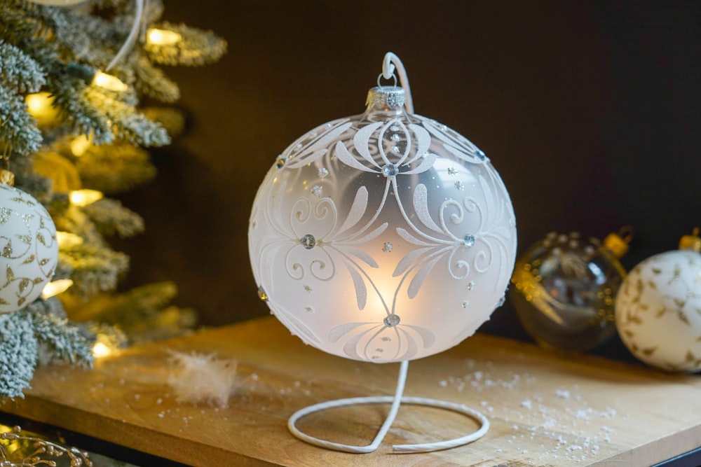 a white ornament sitting on top of a wooden table