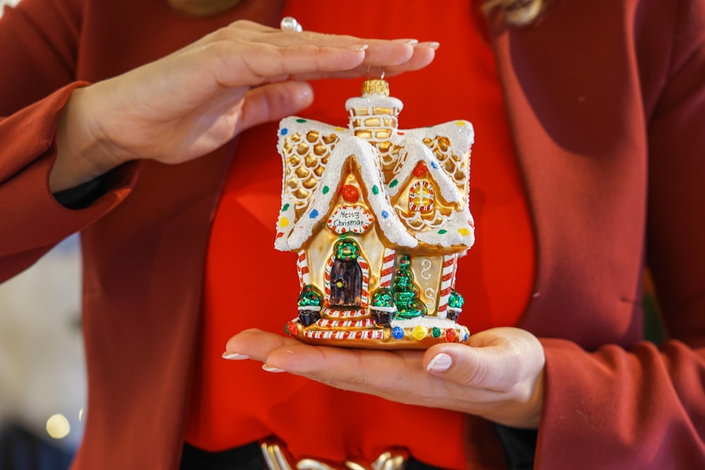 a woman holding a christmas ornament in her hands