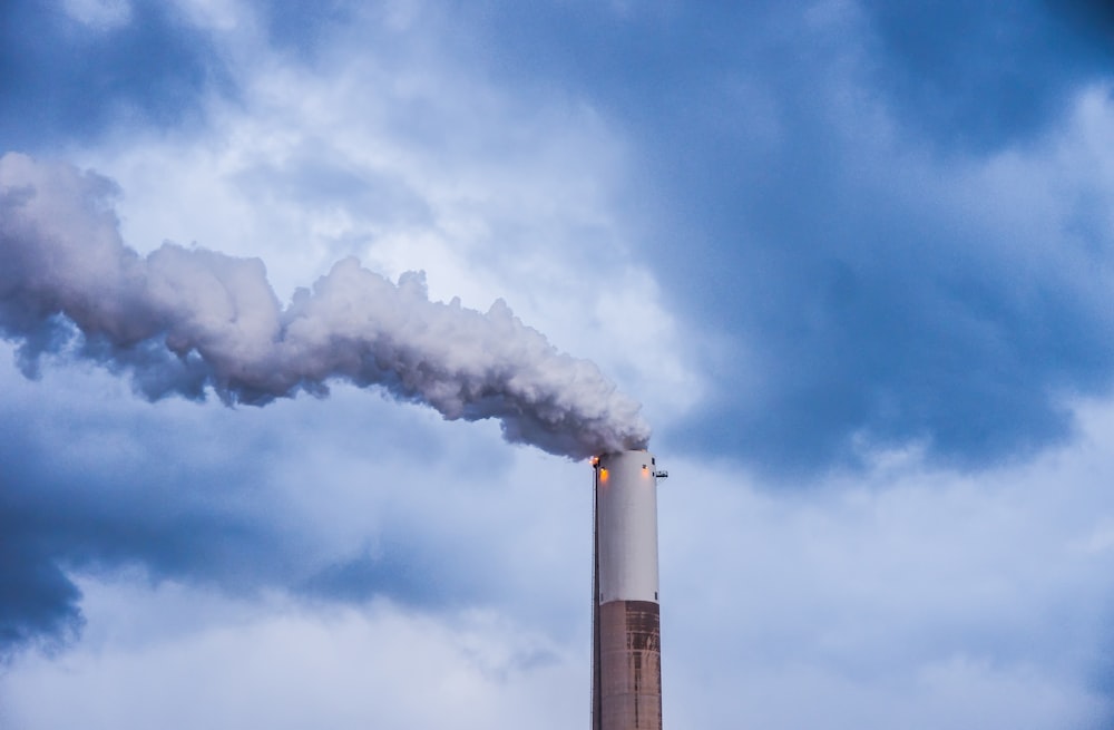 a smokestack emits from the top of a building