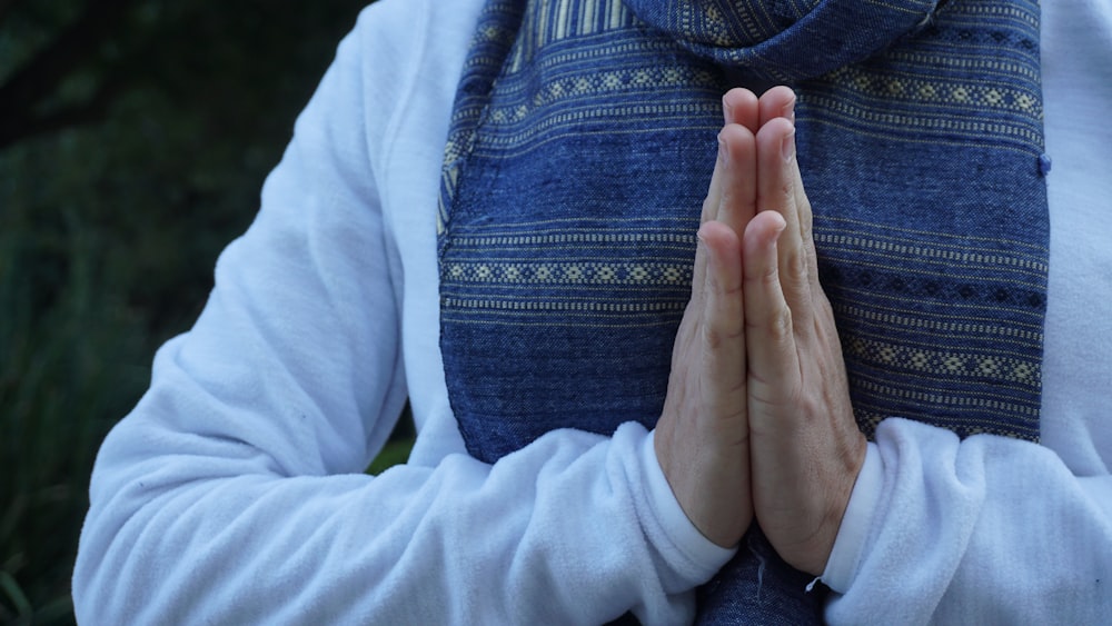 a woman with her hands folded in prayer