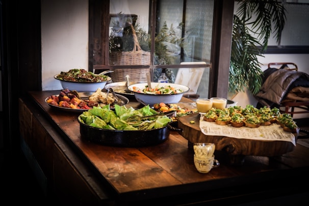 A rustic wooden table with traditional ancestral dishes beautifully arranged, surrounded by natural elements.