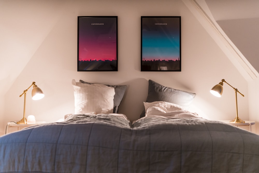 a bed with two framed pictures above it
