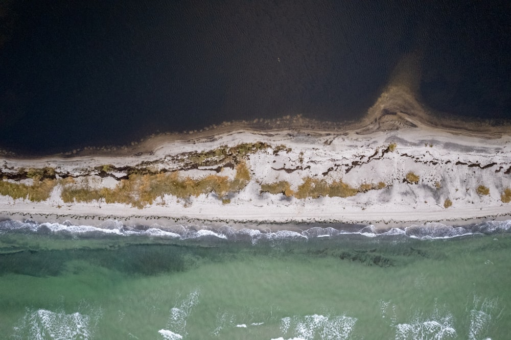 an aerial view of a sandy beach and ocean