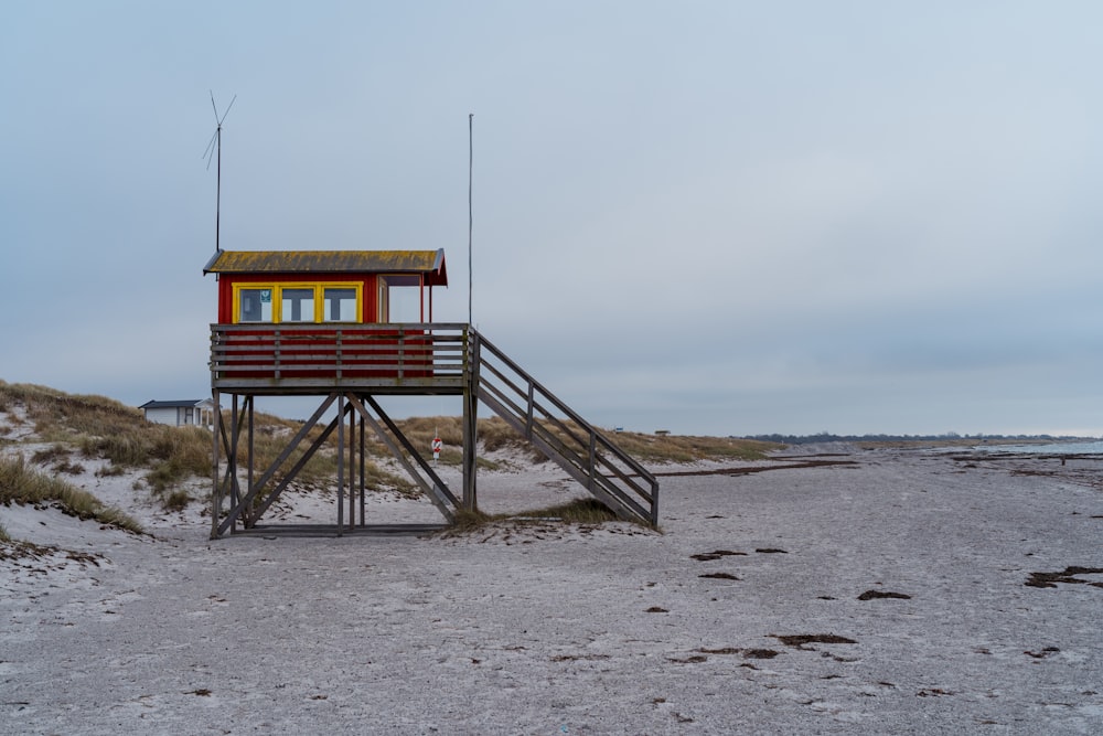 a lifeguard tower on a beach with a ladder