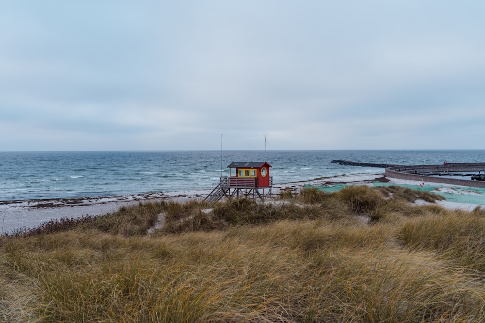 a lifeguard station on a beach next to the ocean