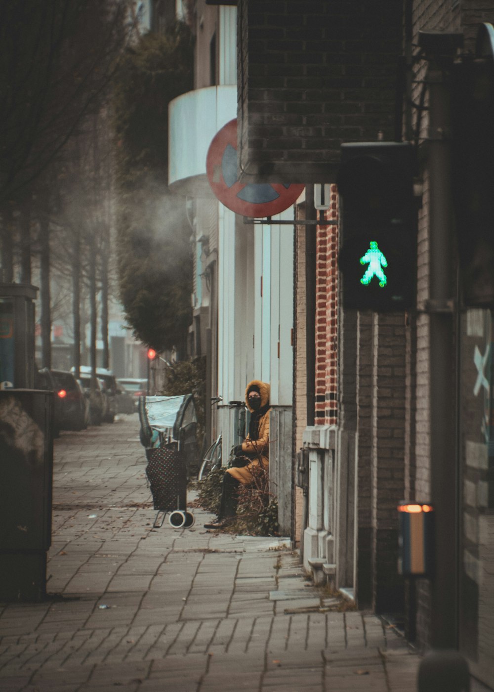 a person sitting on a chair on a sidewalk