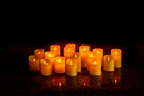 Group photo of several candles arranged to highlight their unique, witty titles