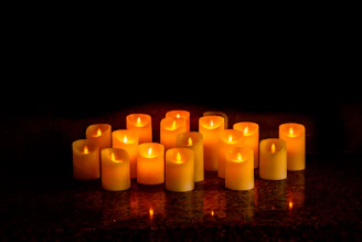Group photo of several candles arranged to highlight their unique, witty titles