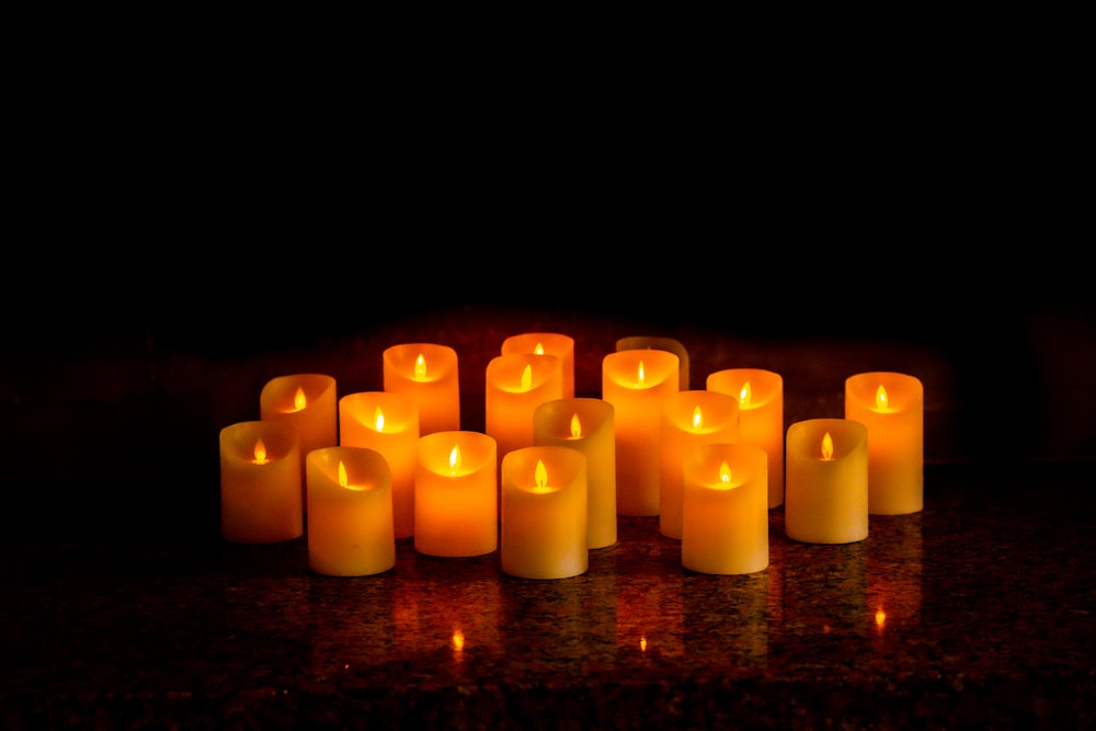 a group of lit candles sitting on top of a table