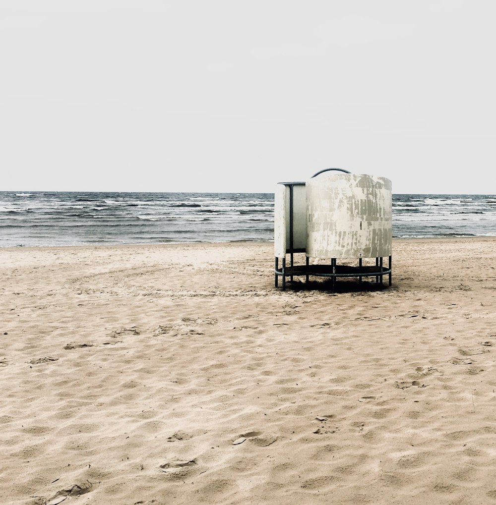 a lifeguard stand on a beach near the ocean