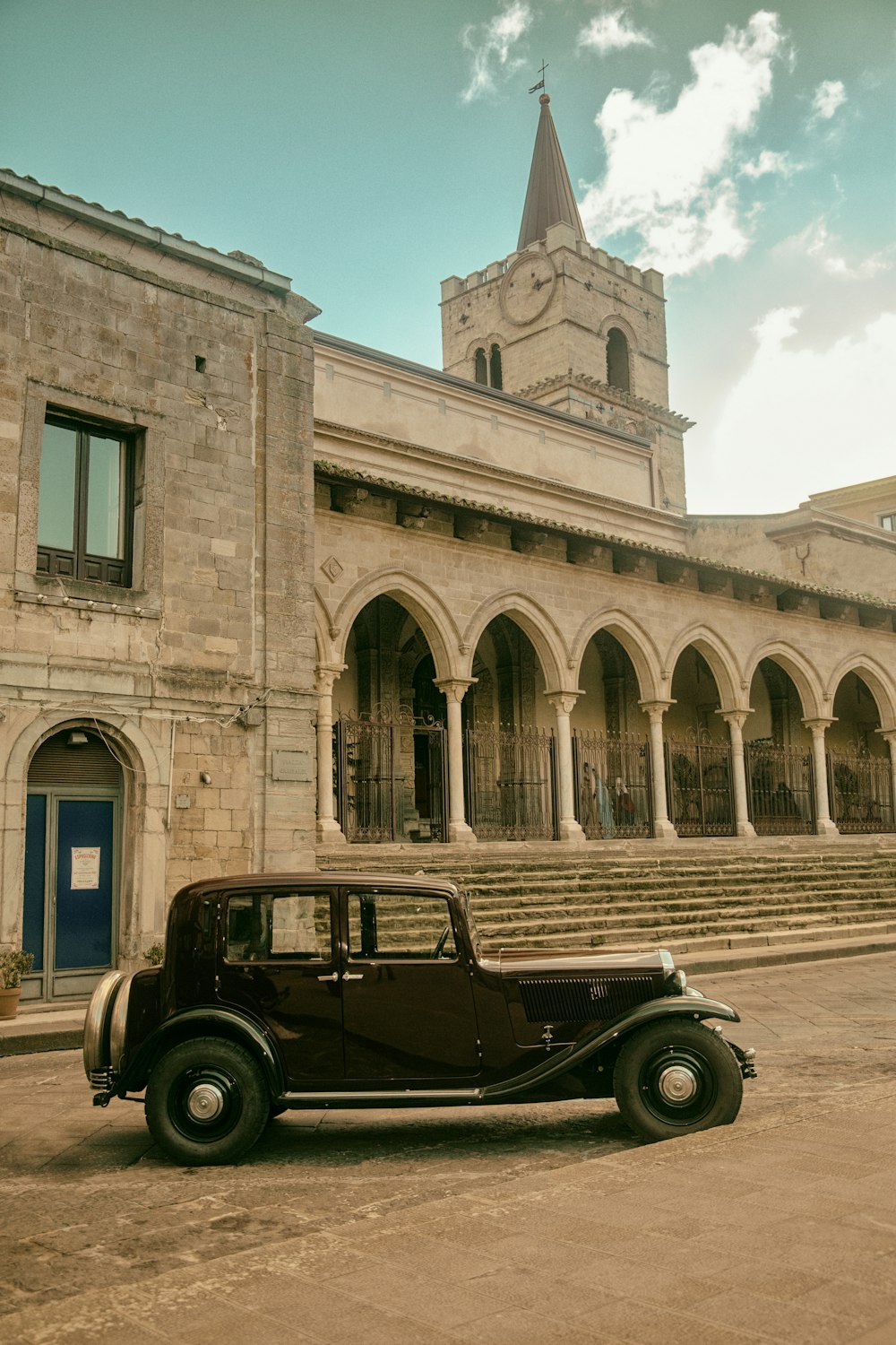 an old car parked in front of a building