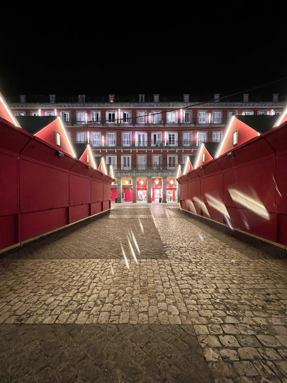 a large building with a red walkway leading to it