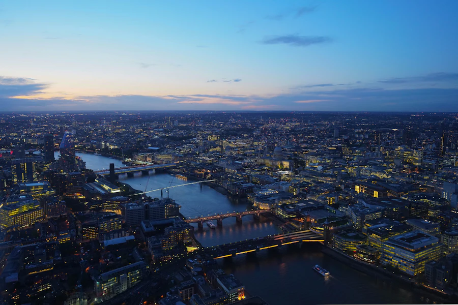 London from above at dusk, the Thames and its bridges lit