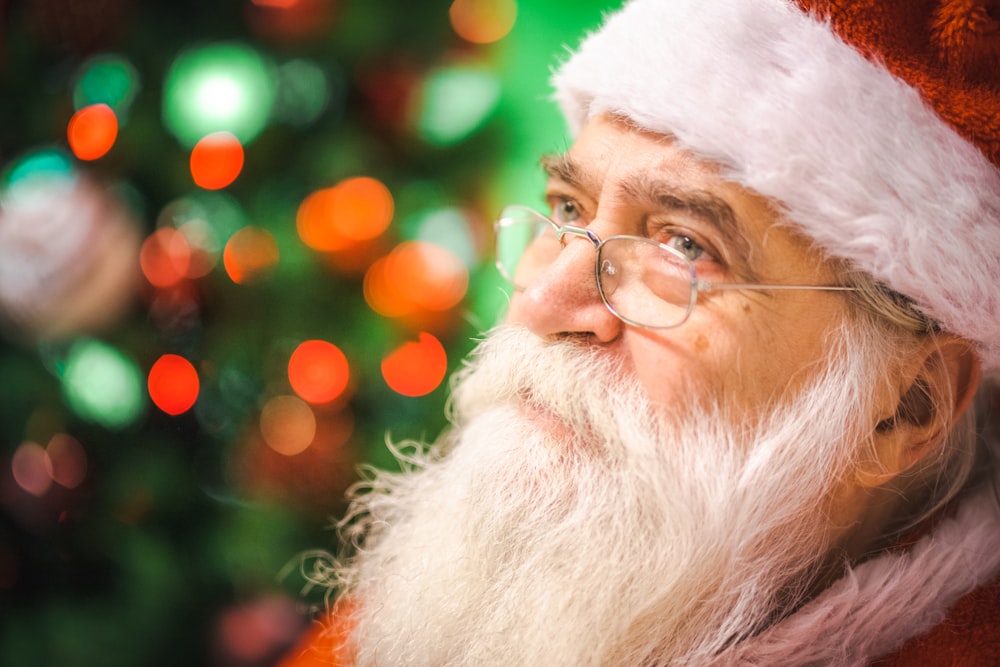 a close up of a person wearing a santa hat