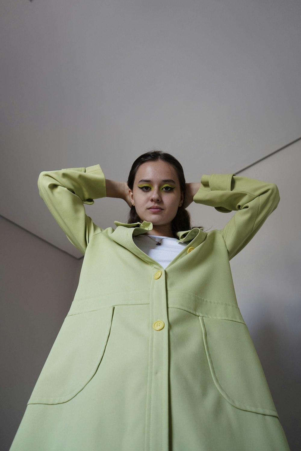 a woman in a green coat posing for a picture