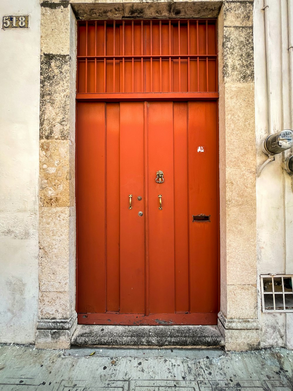 a red door is open on a building