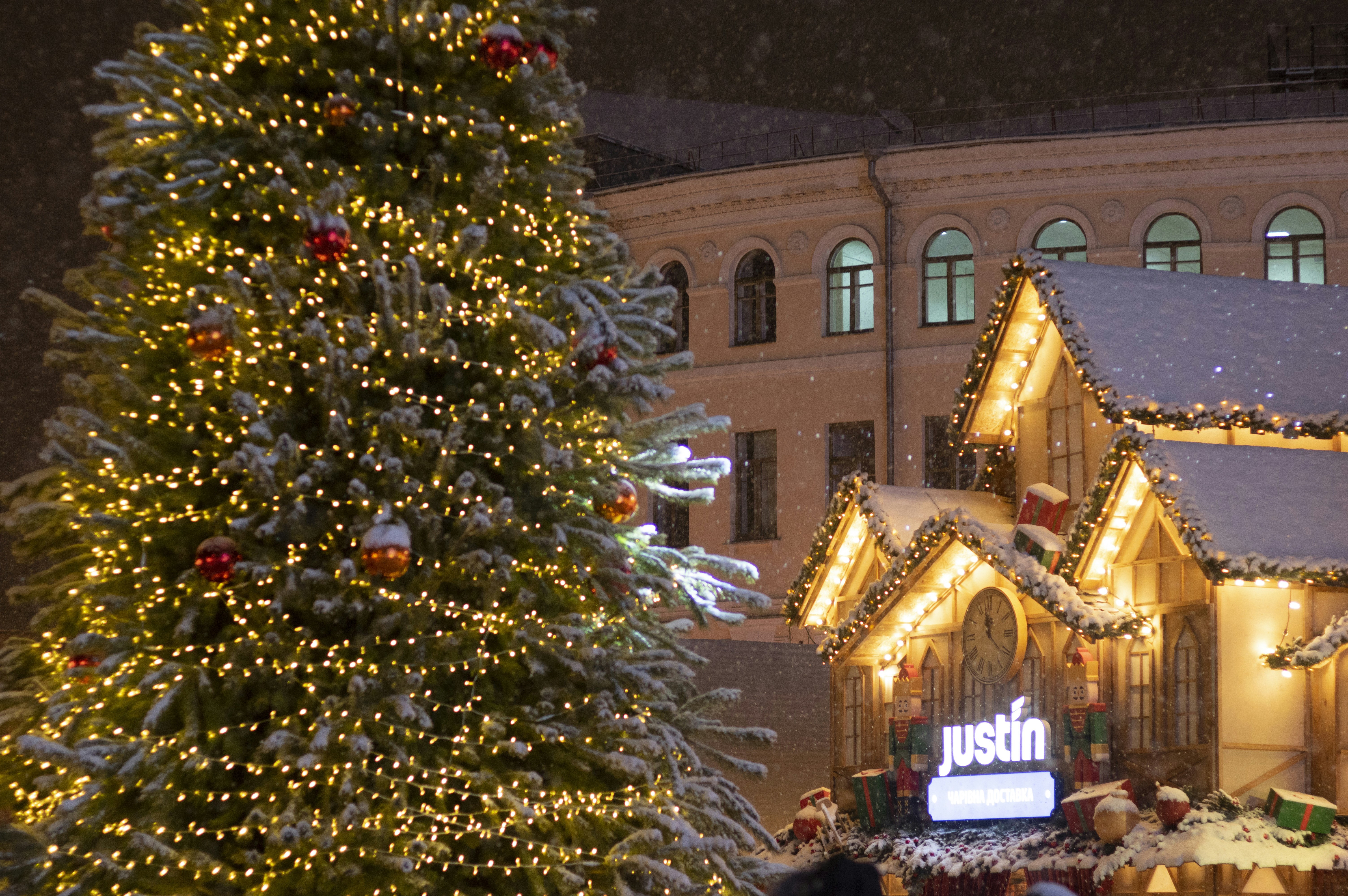 a large christmas tree in front of a building