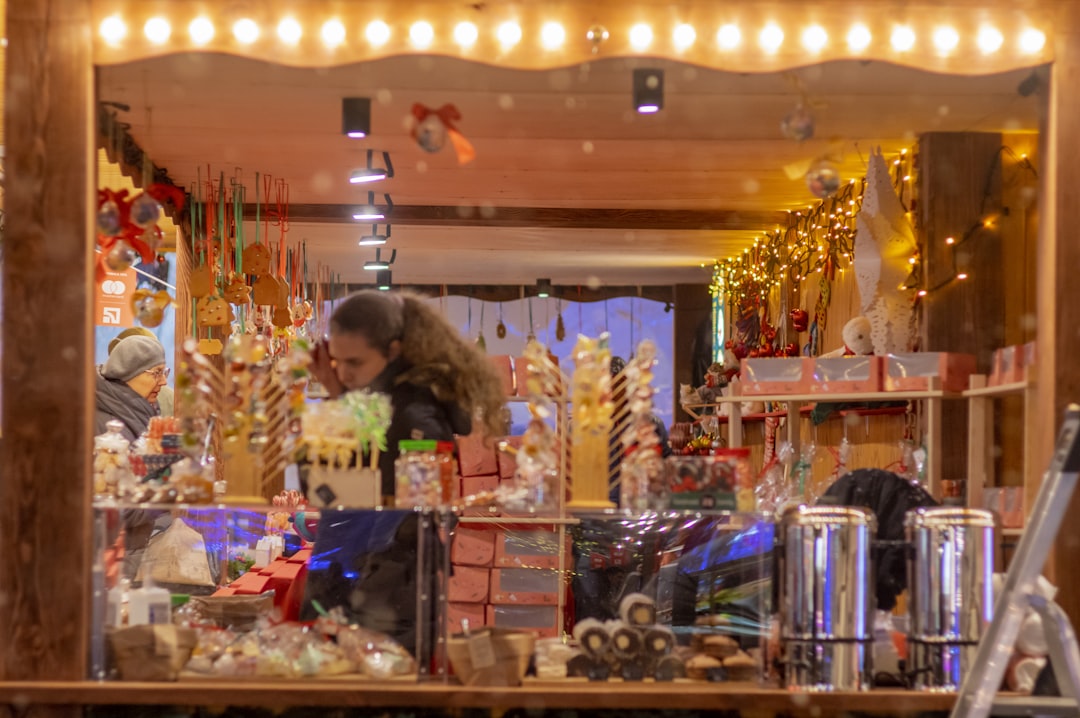 a woman standing in front of a store window,