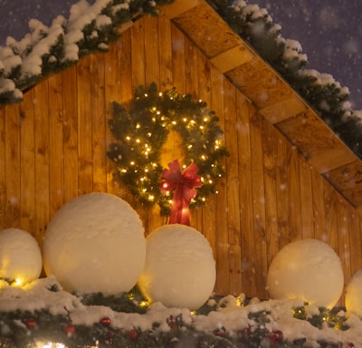 a house with a christmas wreath and lights on it