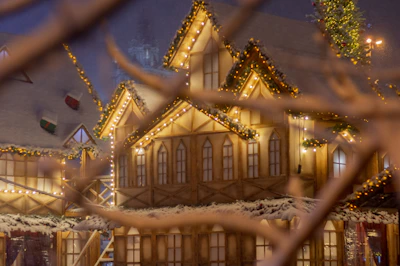 A cozy village scene from a building simulation game with charming houses and animated villagers.