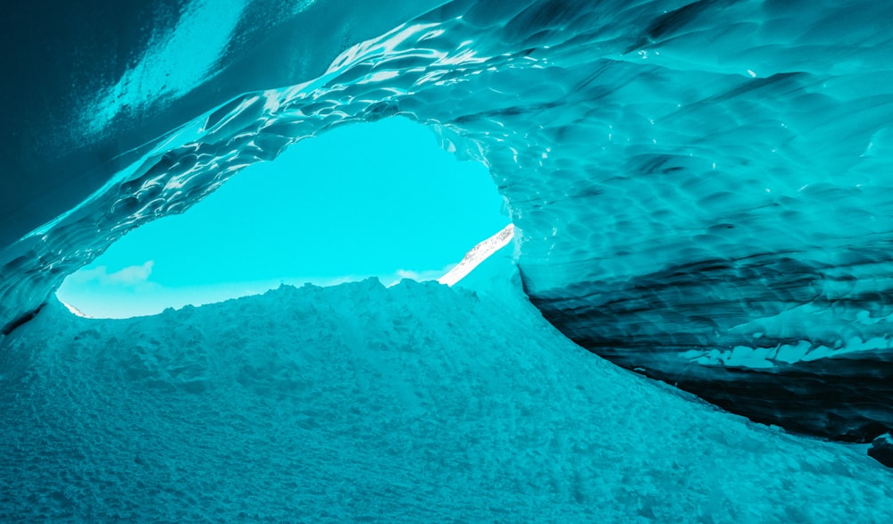 an ice cave with a bright blue sky in the background