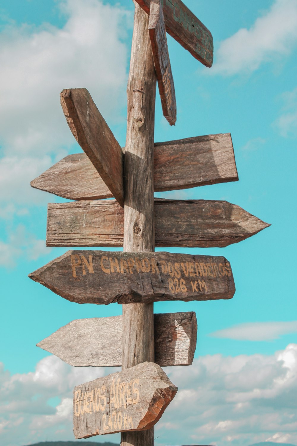 a wooden sign pointing in different directions