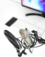 a microphone sitting on top of a desk next to a computer