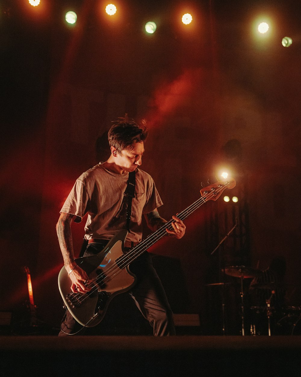 a man playing a bass guitar on a stage