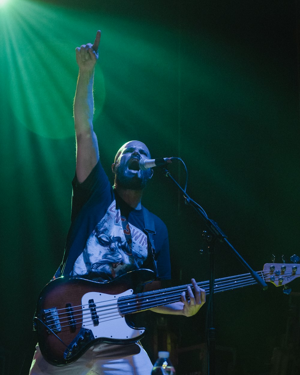 a man holding a guitar up in the air